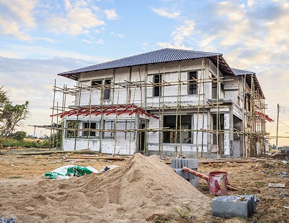 Construction Village team of architects and engineers discussing a home Construction in Meerut.